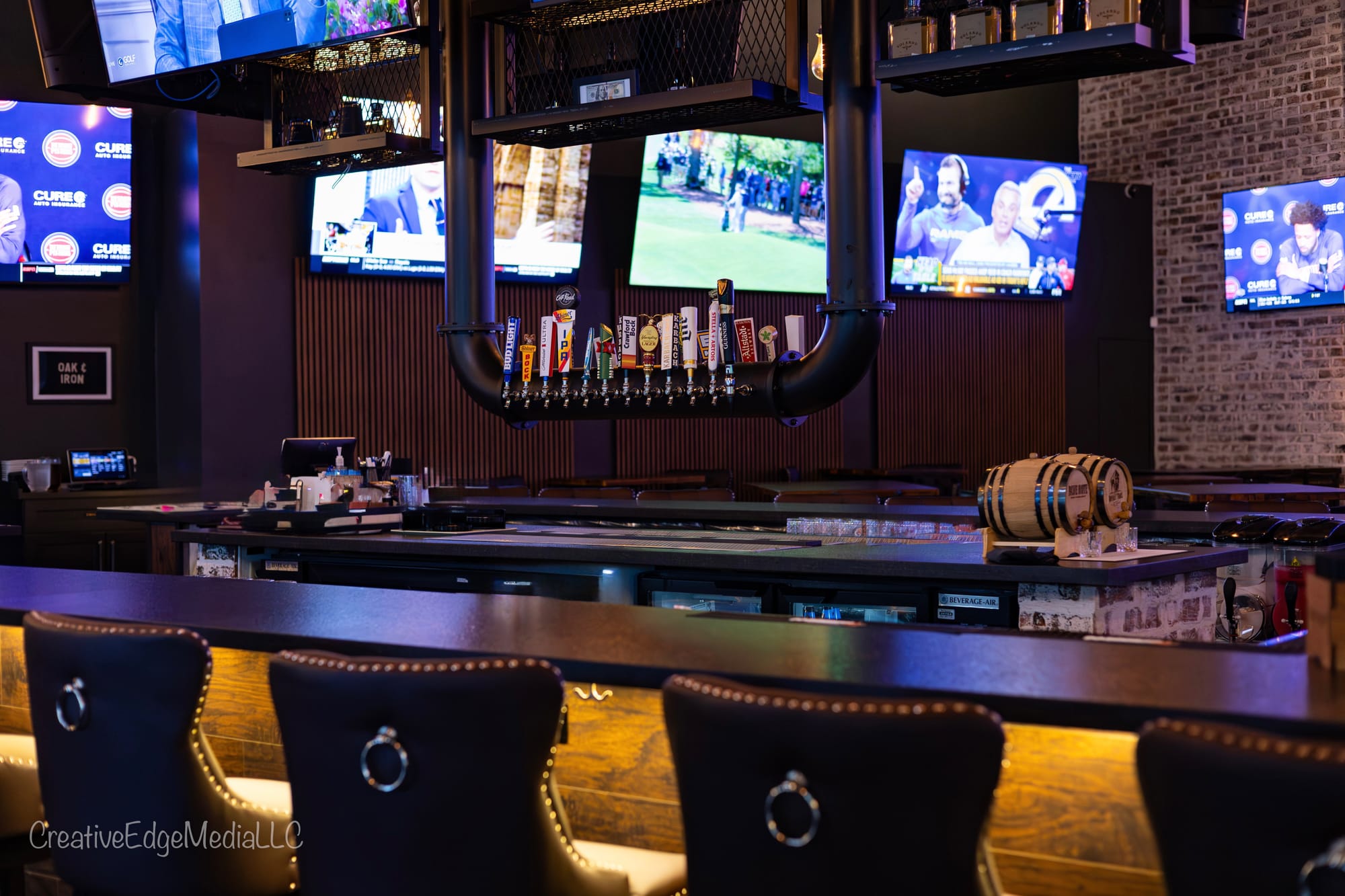 The bar and tap wall at Oak and Iron Sports Social