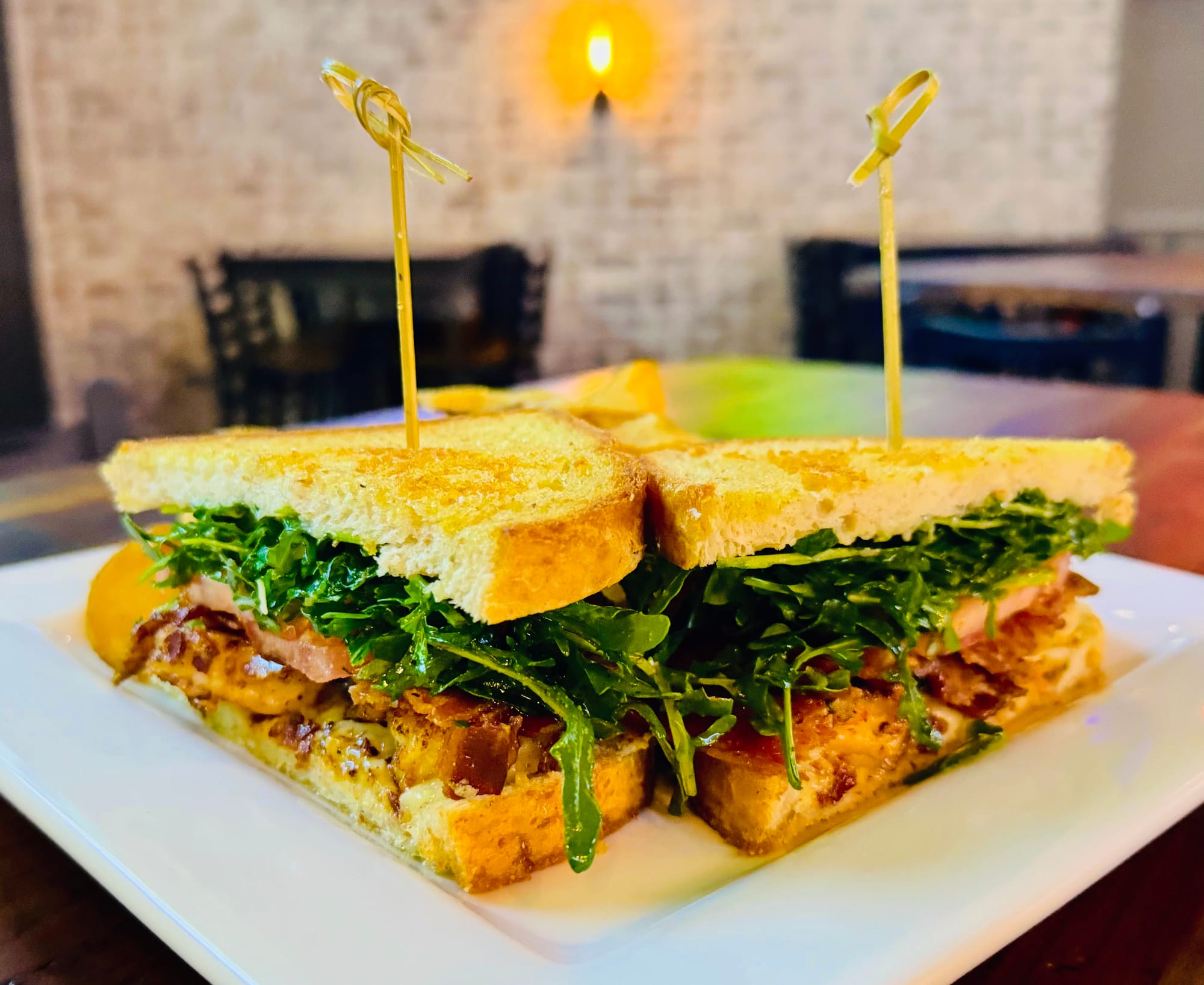 Bayou BLT with arugula served on toasted bread at Oak and Iron