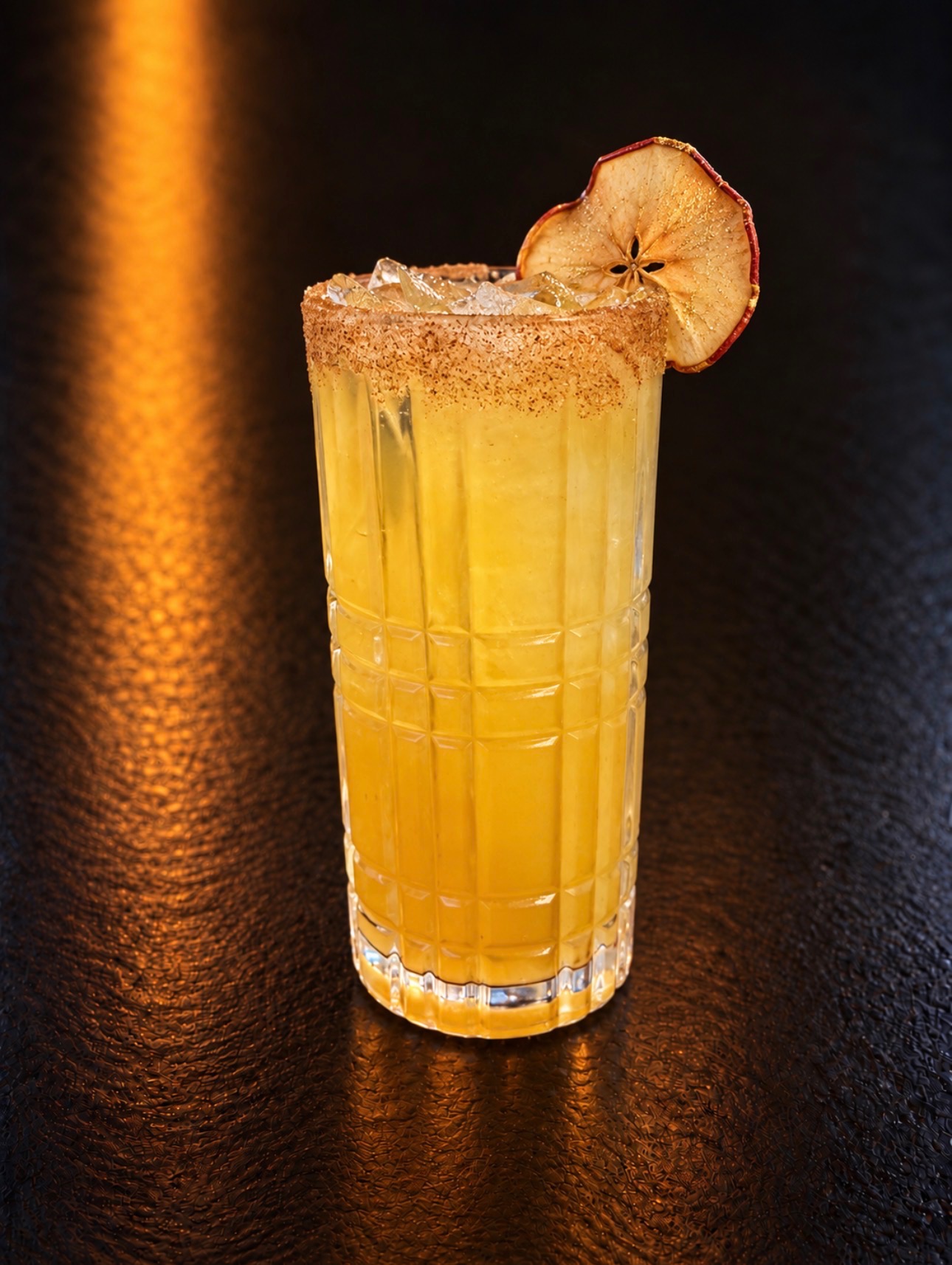 Caramel Apple Crush cocktail with a dried apple garnish at Oak and Iron