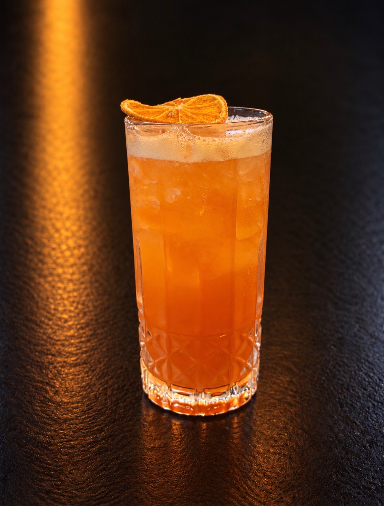 Fall Punch cocktail with a dried orange garnish at Oak and Iron