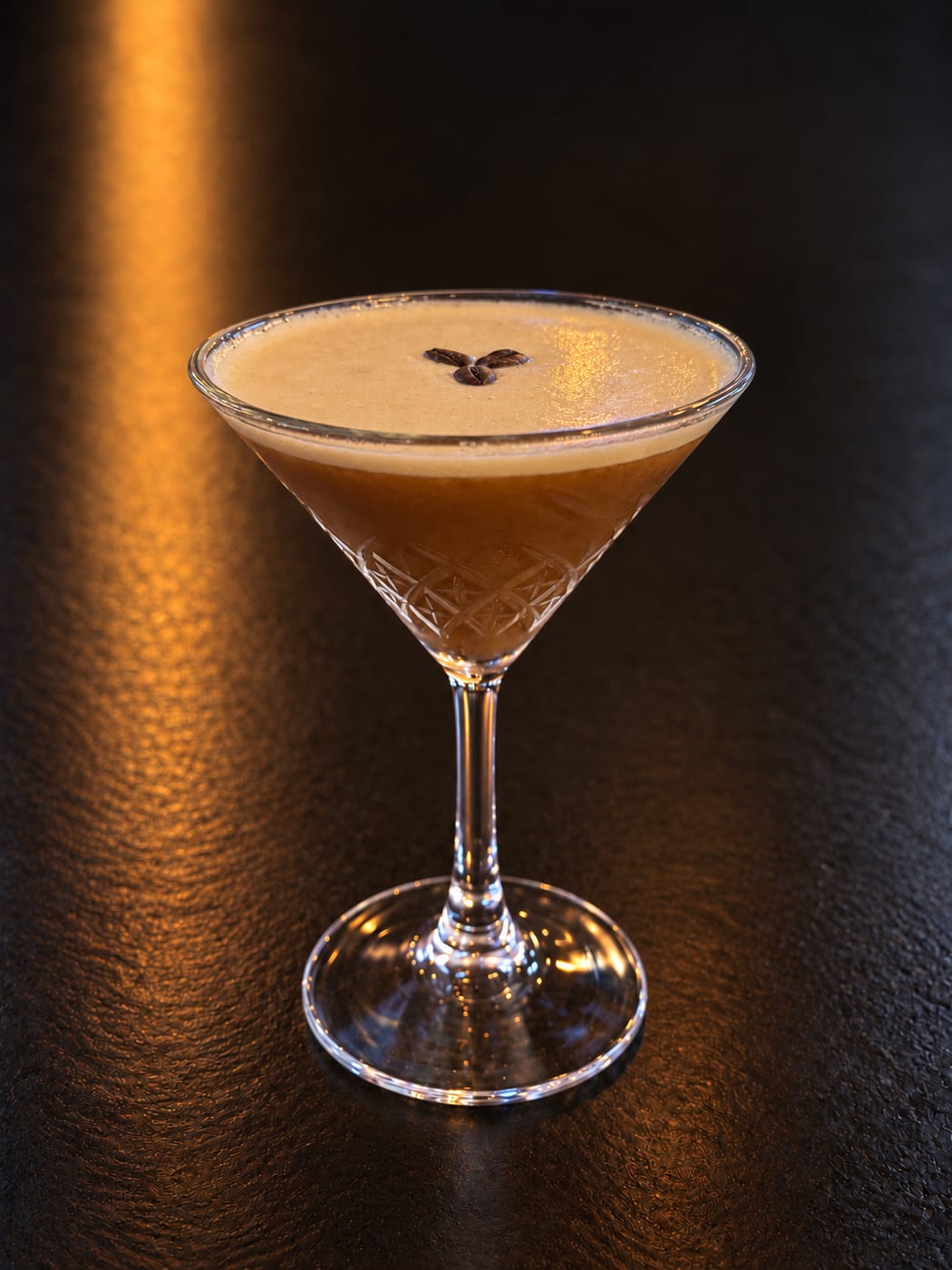Pumpkin Pick-Me-Up martini garnished with coffee beans at Oak and Iron