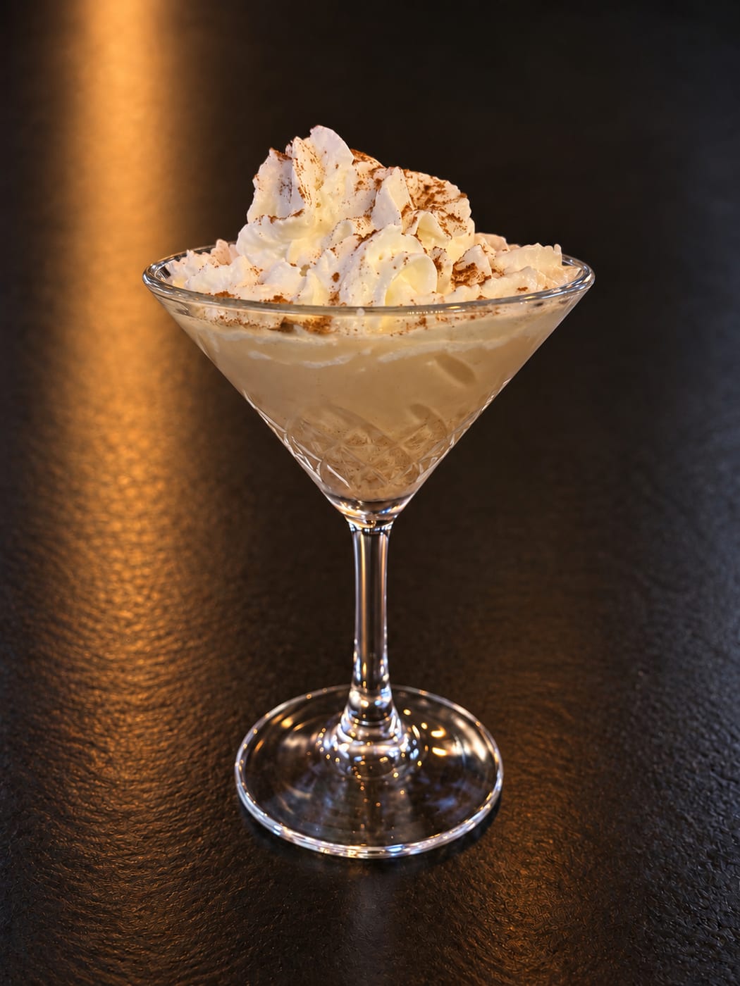 Pumpkin Pie Martini topped with whipped cream and cinnamon at Oak and Iron