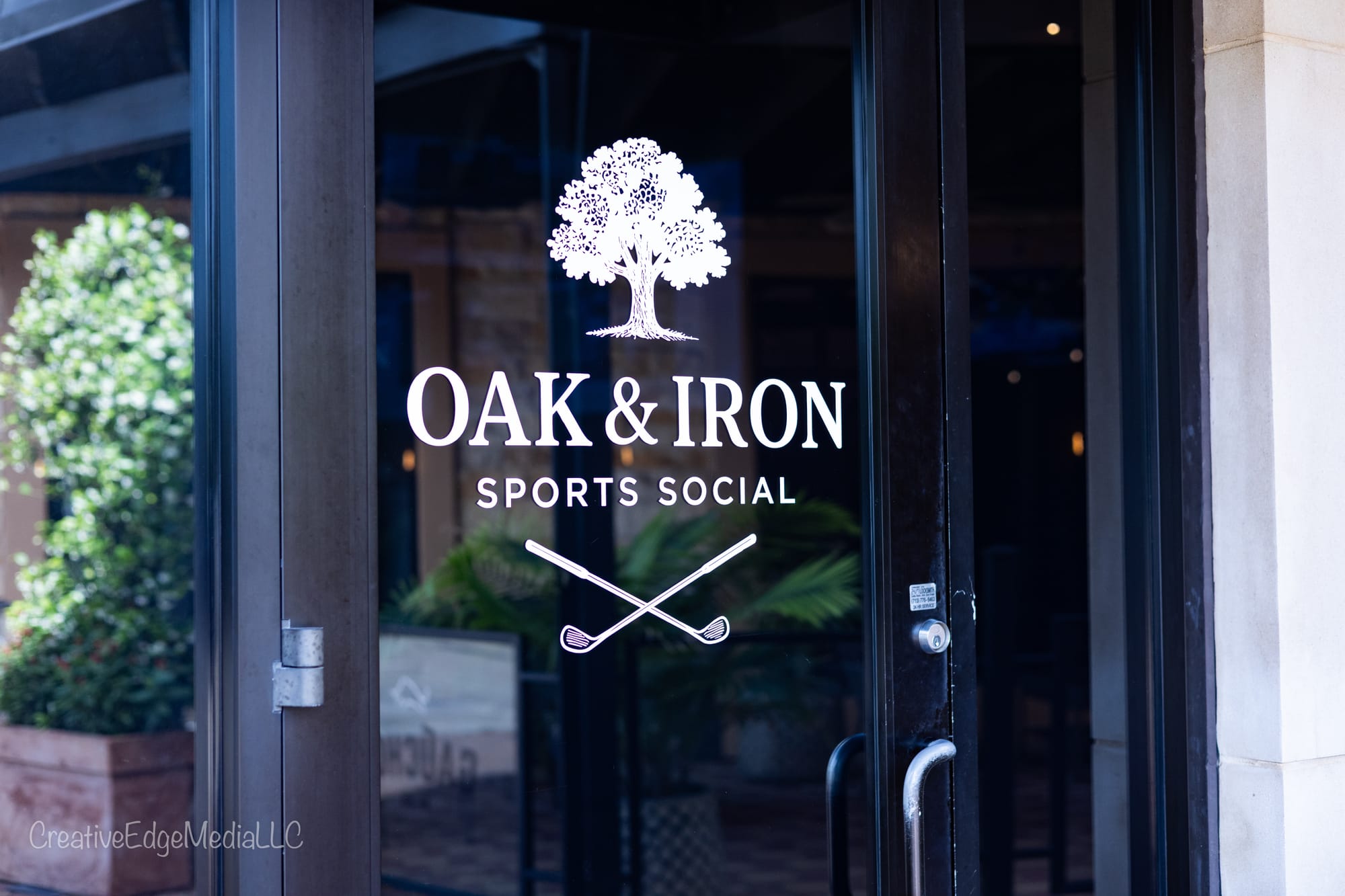 The Oak and Iron Sports Social logo etched on the front door