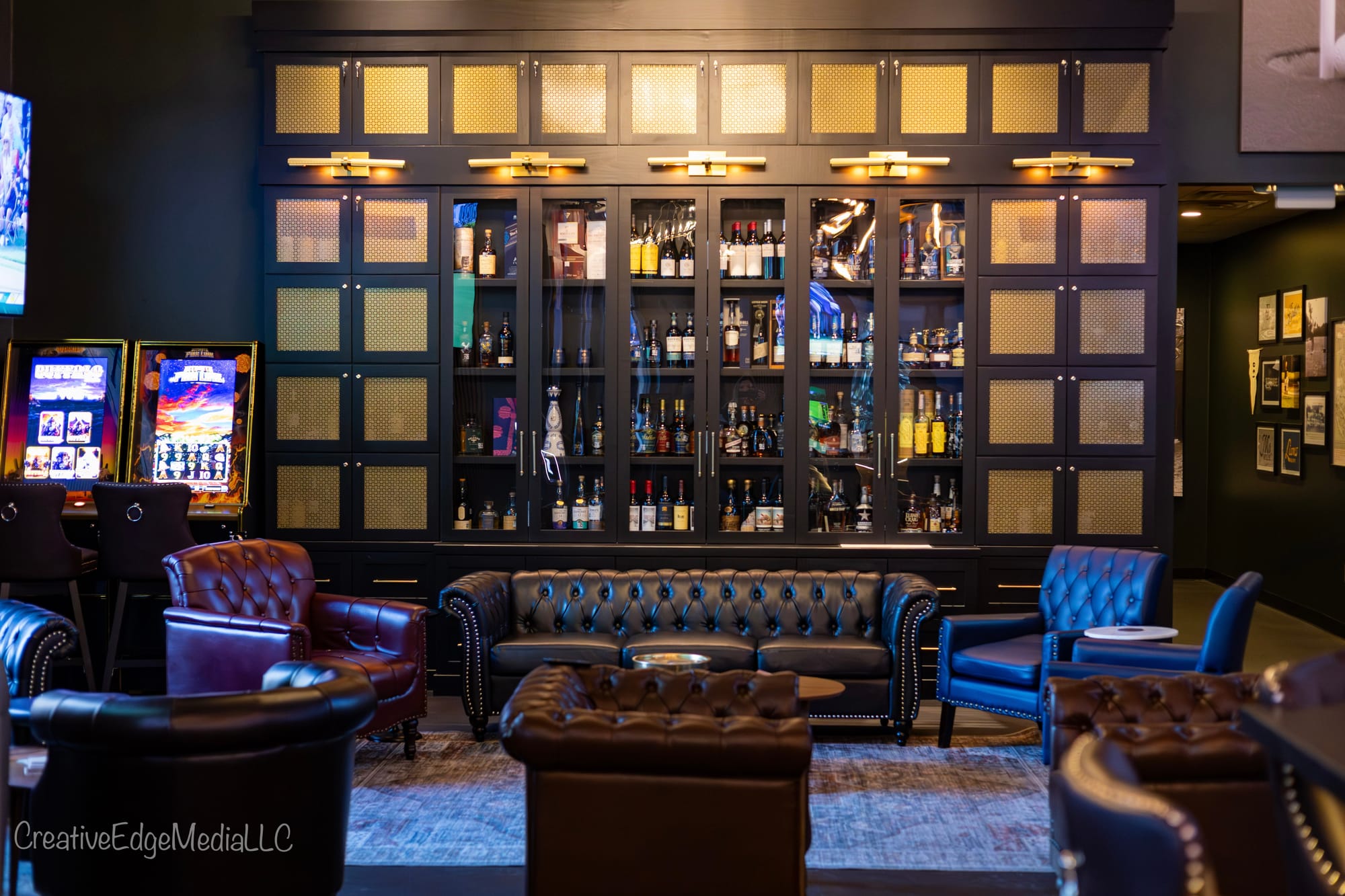The Lounge at Oak and Iron with dark finishes, leather seating and warm brass lighting