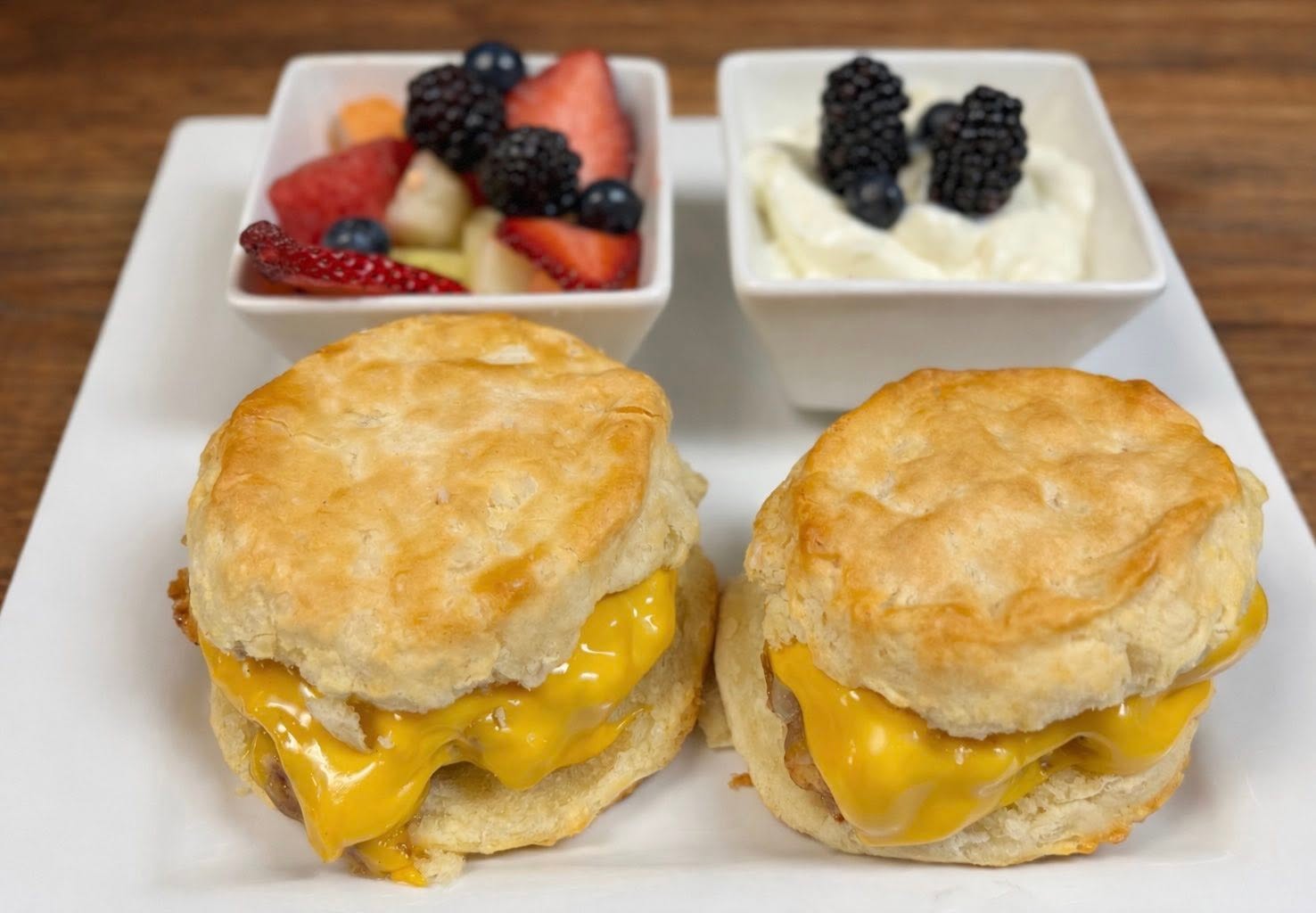 Breakfast biscuit sandwiches with fruit served at Oak and Iron